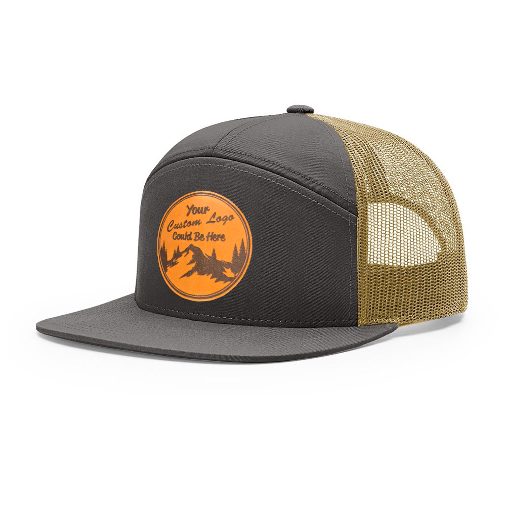 A black and brown Richardson 7-Panel trucker hat with a leather patch on the front featuring an orange and white design.