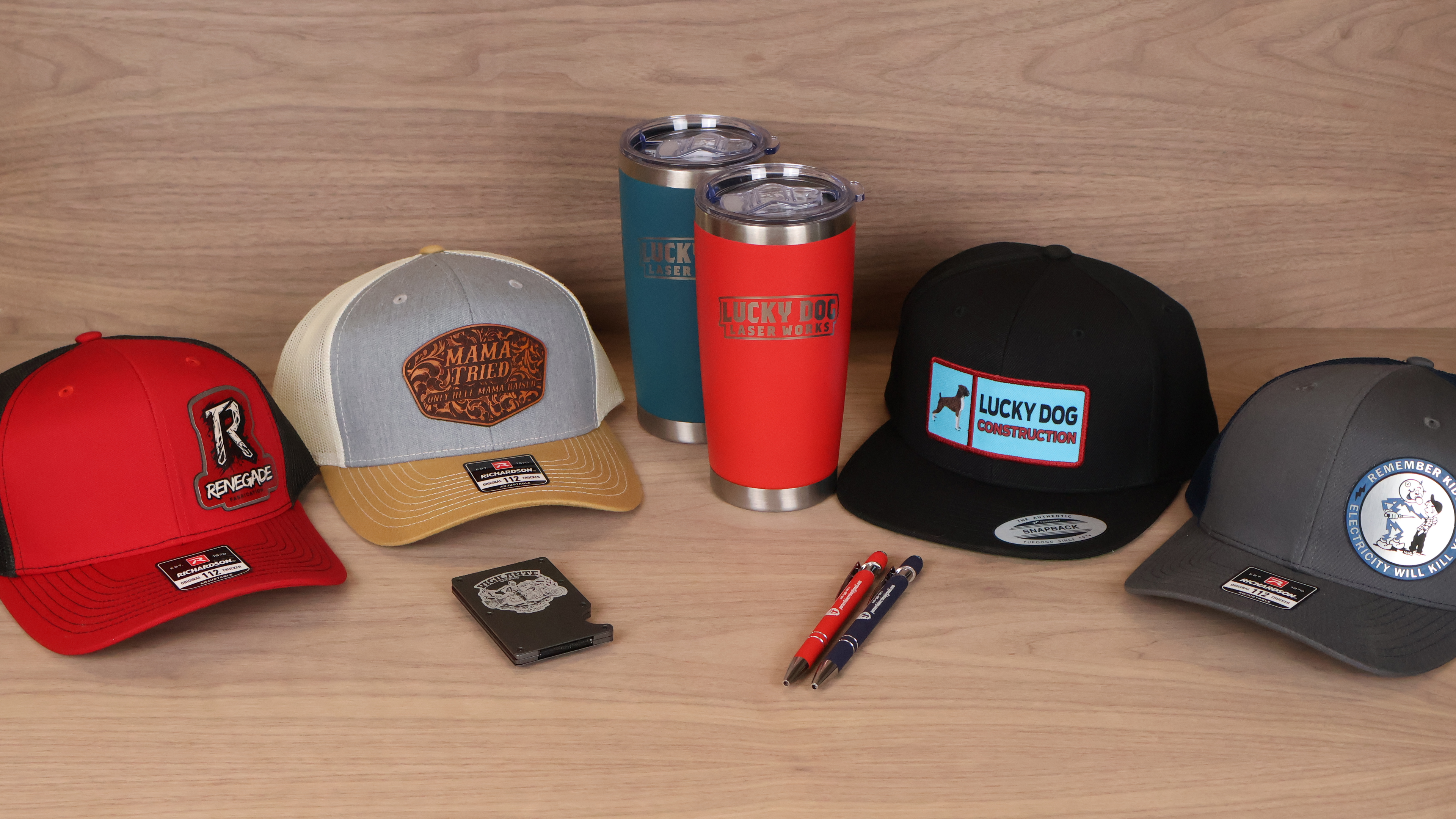 Custom branded merch including embroidered hats and laser engraved tumblers for businesses and teams in Idaho Falls at Lucky Dog Branding