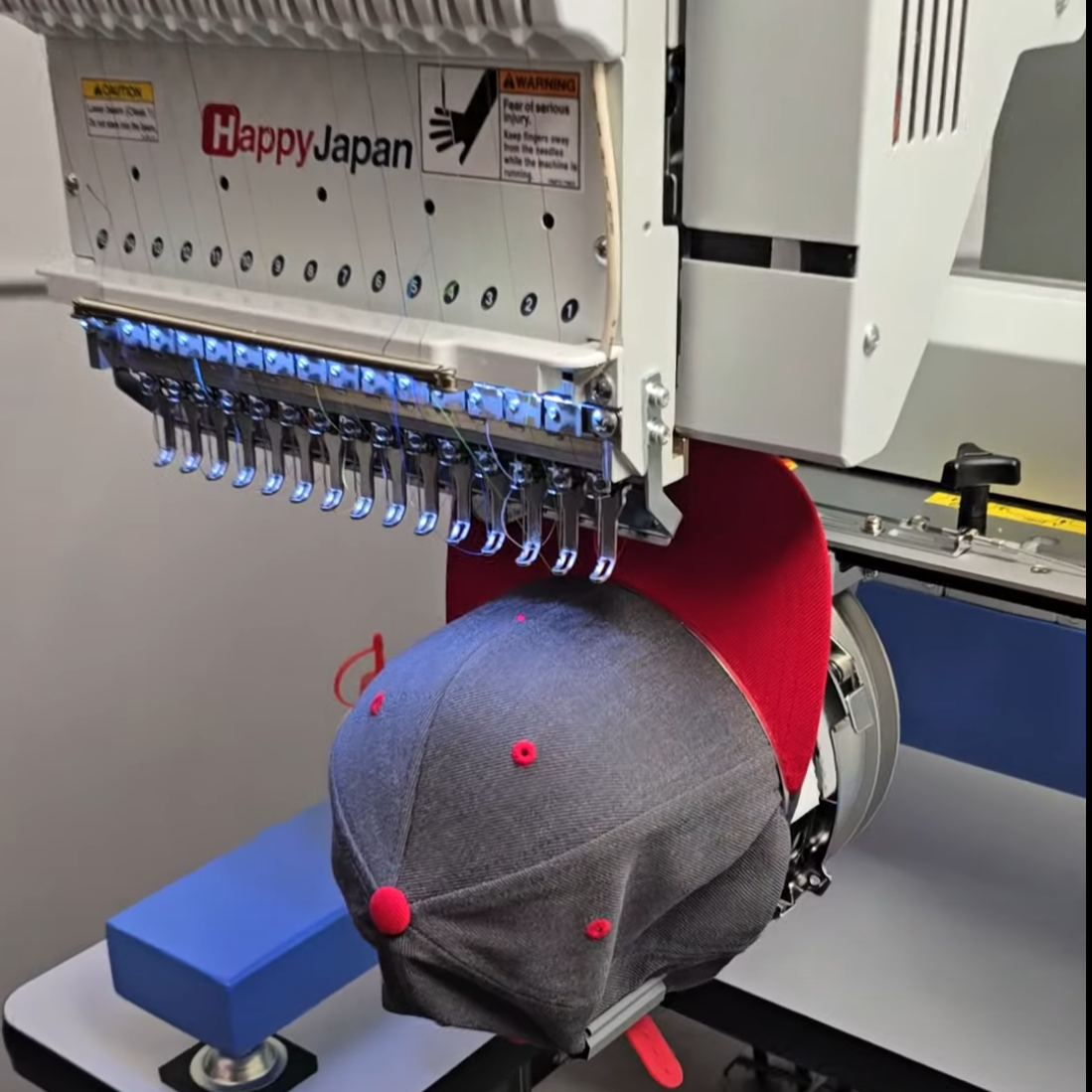 Happy Japan industrial embroidery machine stitching custom embroidered hats for businesses in Idaho Falls